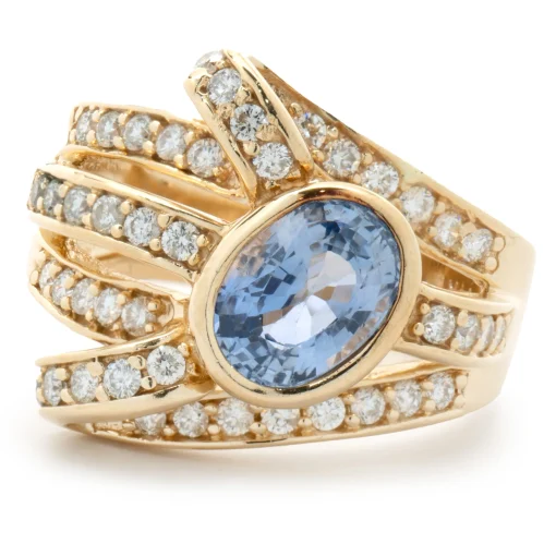 14 Karat Yellow Gold Bezel Set Cornflower Blue Sapphire and Diamond Bypass Ring