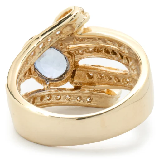 14 Karat Yellow Gold Bezel Set Cornflower Blue Sapphire and Diamond Bypass Ring